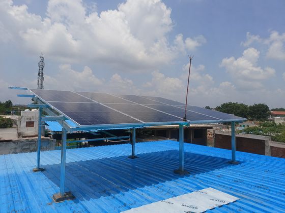 Solar panels mounted above a blue metal-sheet roof