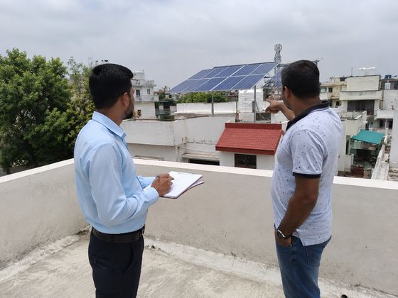 Customer discussion during a rooftop solar site visit